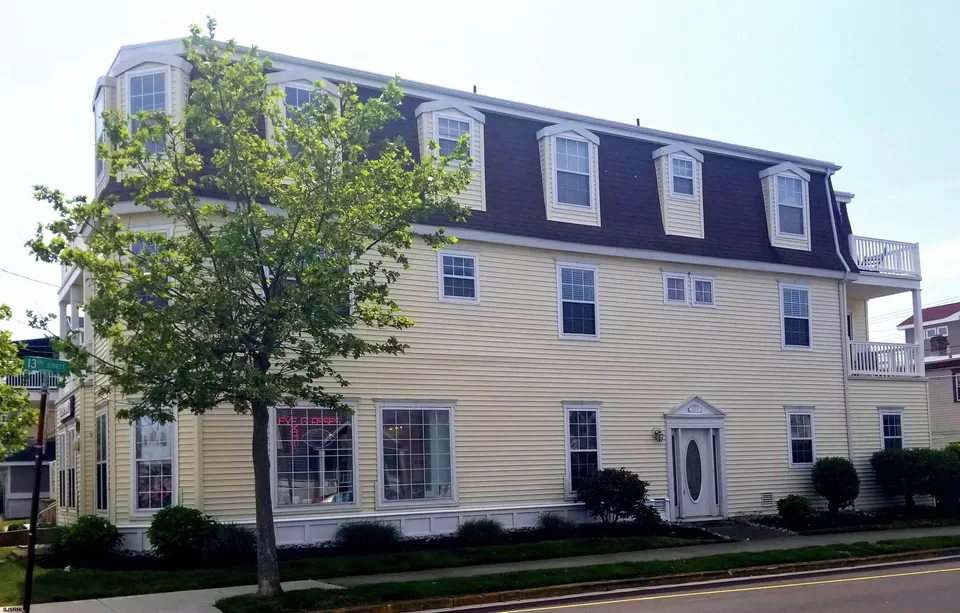 We see a beige house in Ocean City, NJ against a clear blue sky.