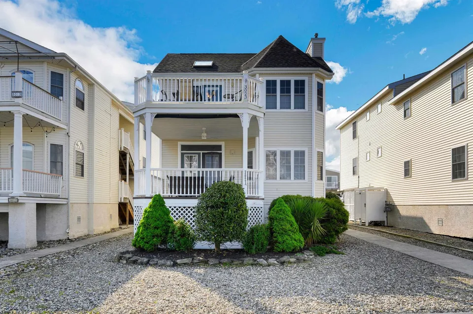 We see a beige house up against a clear blue sky.