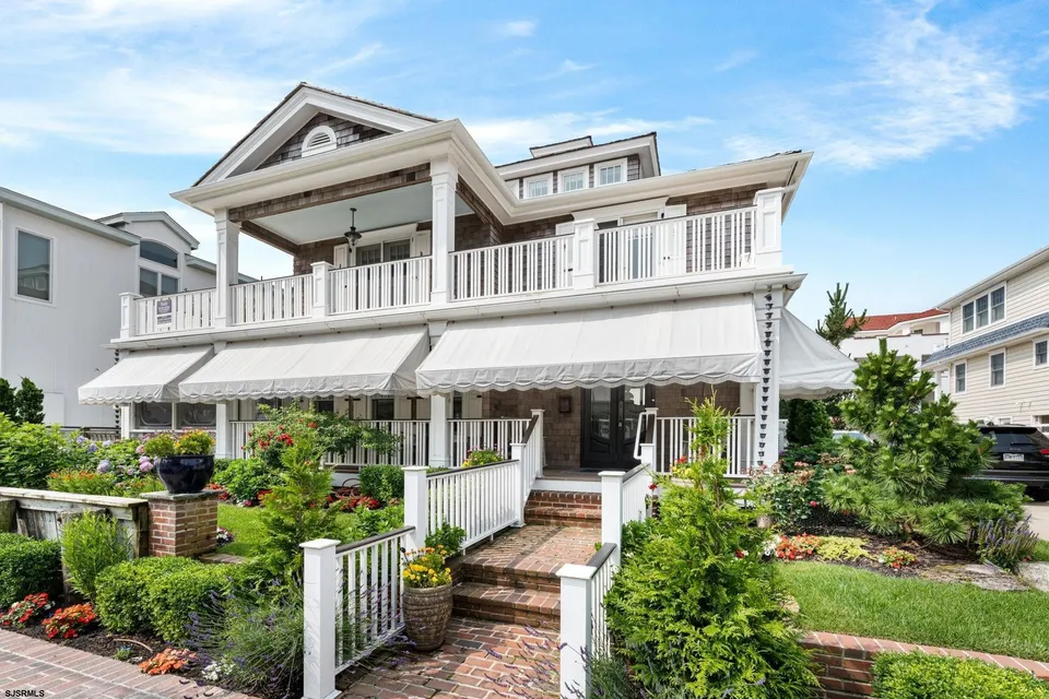 We see a picture of a white house in Ocean City, NJ against a clear blue sky.