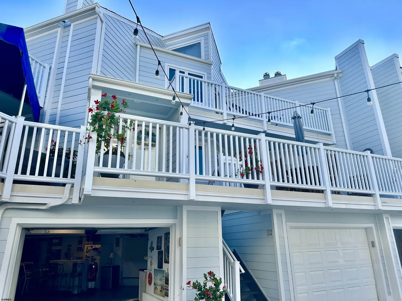 We see the front of a light blue and white house in Ocean City, NJ.