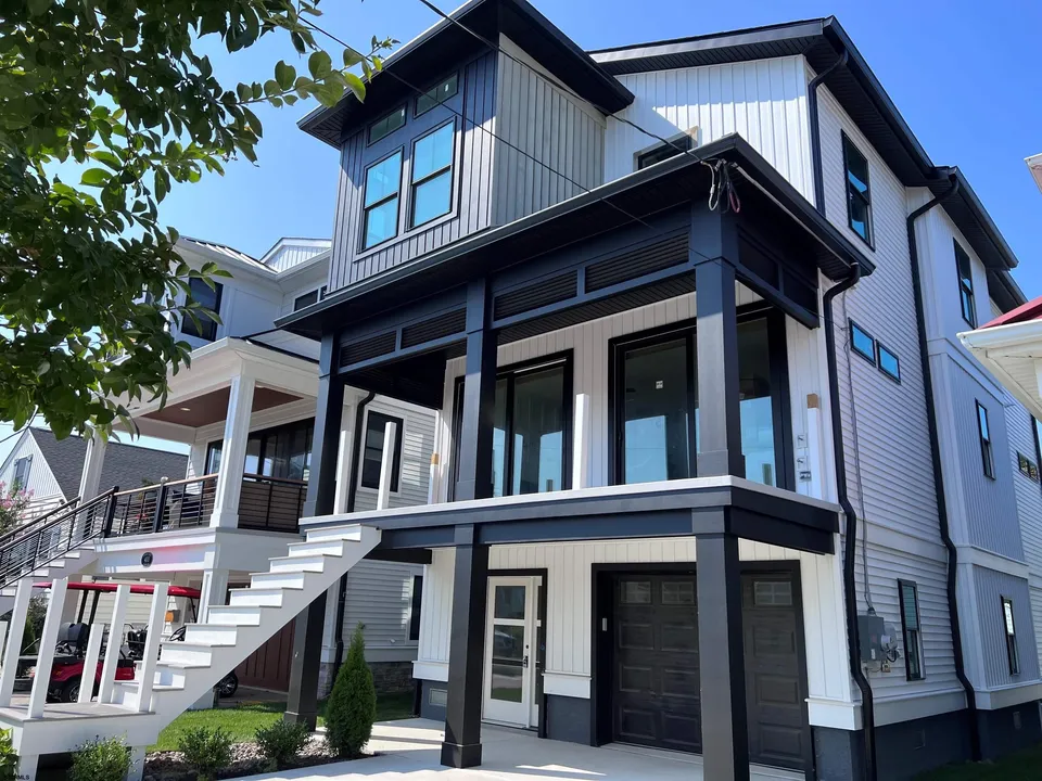 We see the front of a blue and white house in Ocean City, NJ.