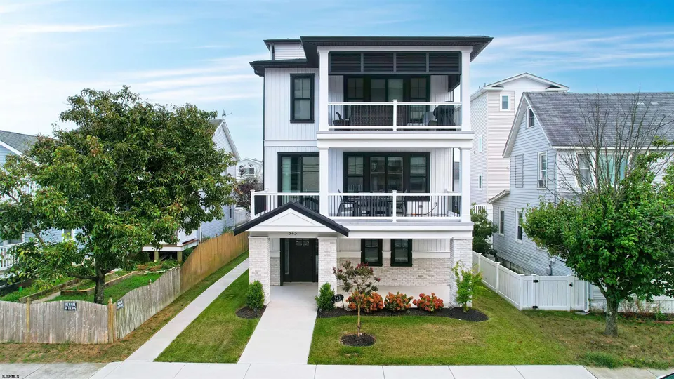 We see the front of a white and black house in Ocean City, NJ.