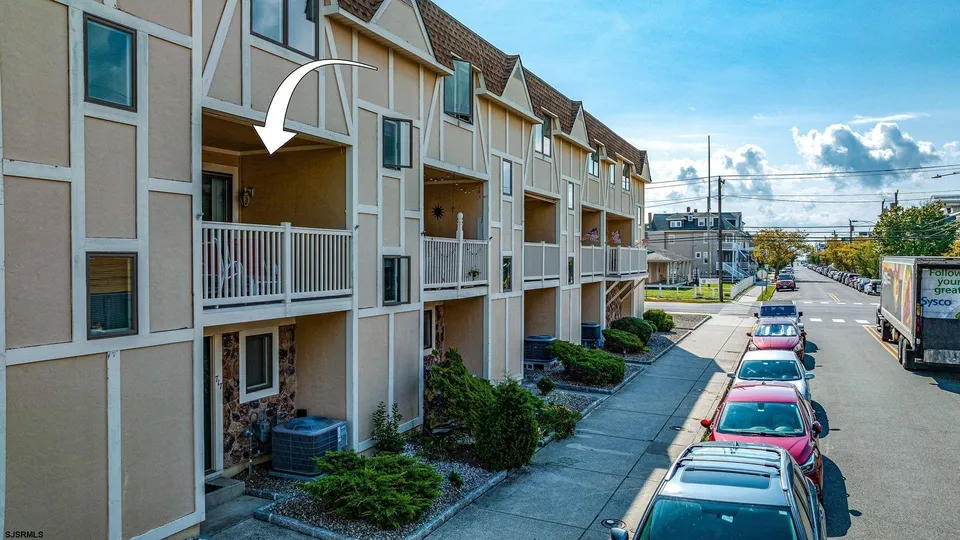 We see the front of a beige townhouse in Ocean City, NJ.